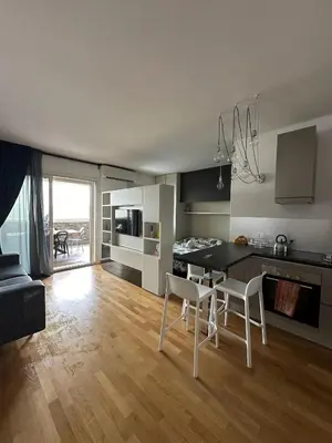 a kitchen and living room with a table and chairs at Modern Loft Private in Rome