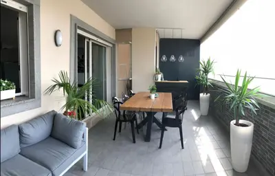 a patio with a table and chairs and a couch at Modern Loft Private in Rome