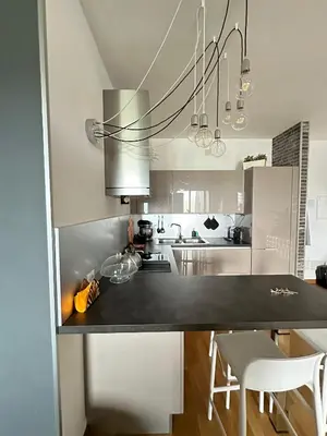 a kitchen with a black counter top in a room at Modern Loft Private in Rome
