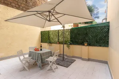 a table and chairs with an umbrella on a patio at Domus Erasmo in Rome