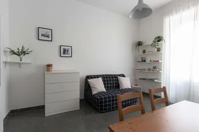 a living room with a chair and a table at Domus Erasmo in Rome