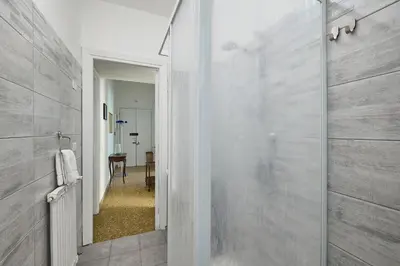 a bathroom with a shower with a glass door at Domus Erasmo in Rome