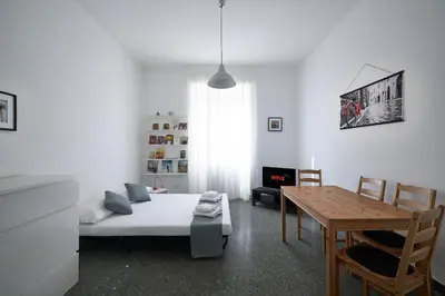 a bedroom with a bed and a table and a dining room at Domus Erasmo in Rome