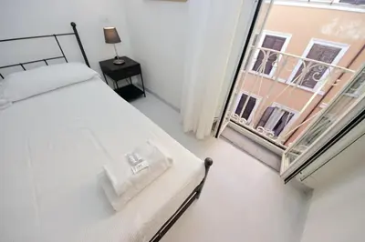 a bedroom with a bed and a large window at Monti Charming Apt Boschetto in Rome