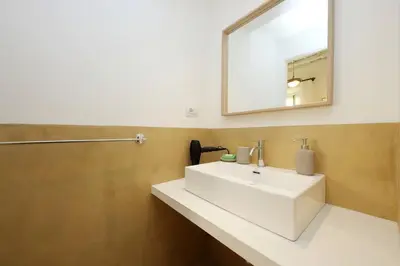 a bathroom with a white sink and a mirror at Monti Charming Apt Boschetto in Rome