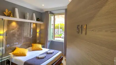 a bedroom with a bed with yellow pillows and a window at Hotel Giolitti Smart in Rome