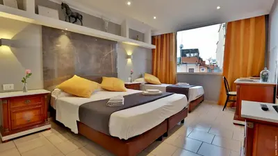 a hotel room with two beds and a balcony at Hotel Giolitti Smart in Rome