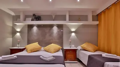 two beds with yellow pillows in a room at Hotel Giolitti Smart in Rome