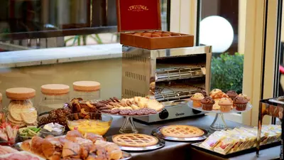 a buffet of pastries and breads on a table at Hotel Giolitti Smart in Rome