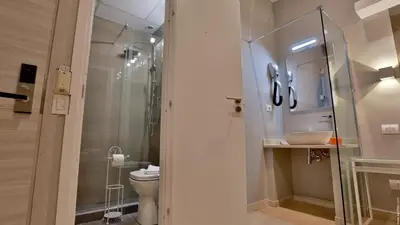 a bathroom with a shower and a toilet and a sink at Hotel Giolitti Smart in Rome