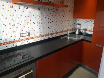 a kitchen with red cabinets and a sink at Gallia in Rome