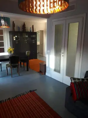 a living room with a table and a dining room at Gallia in Rome