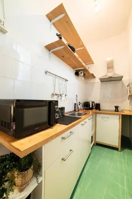 a kitchen with white cabinets and a microwave at The Pope's House in Rome