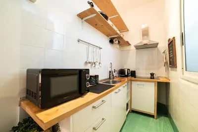 a kitchen with a microwave on a wooden counter at The Pope's House in Rome
