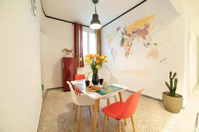 a dining room with a table and chairs with a map on the wall at The Pope's House in Rome