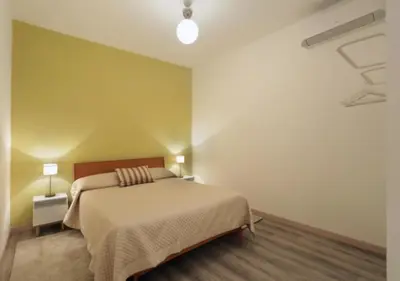 a bedroom with a bed and a green wall at Centro Roma Cortile - LOCAPPART in Rome