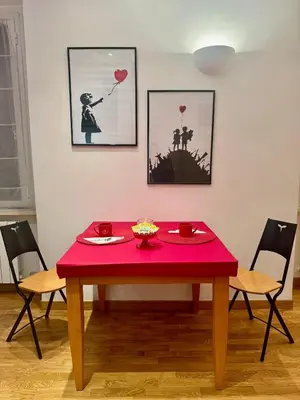 a table with a red table cloth on top of it at Ao Apartment in Rome