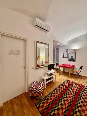 a living room with a table and a red table at Ao Apartment in Rome