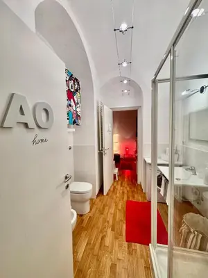 a bathroom with a toilet and a sink at Ao Apartment in Rome