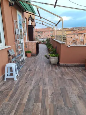 a balcony with a wooden floor and a building at La Terrazza su Roma in Rome