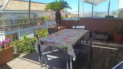 a table and chairs sitting on a balcony at La Terrazza su Roma in Rome