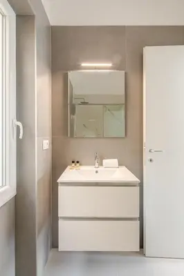 a bathroom with a white sink and a mirror at Sunset House - San Paolo in Rome