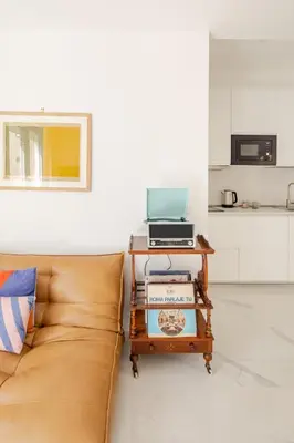 a living room with a couch and a table with a laptop at Sunset House - San Paolo in Rome