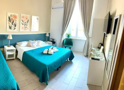 a hotel room with a bed and a television at Girasole Guesthouse in Rome
