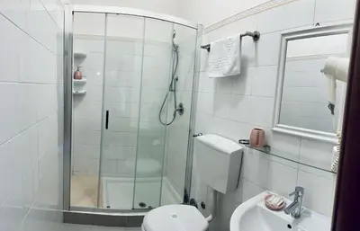 a bathroom with a shower and a toilet and a sink at Girasole Guesthouse in Rome
