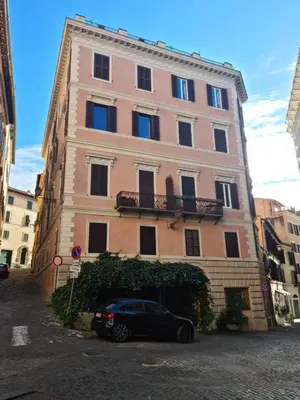 a building with a car parked in front of it at Il Grillo ai Fori Romani in Rome