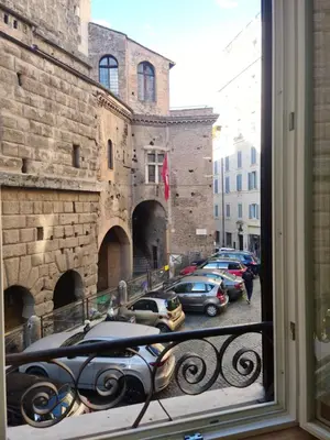a view from a window of a street with parked cars at Il Grillo ai Fori Romani in Rome