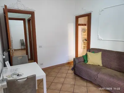 a living room with a couch and a table at Il Grillo ai Fori Romani in Rome