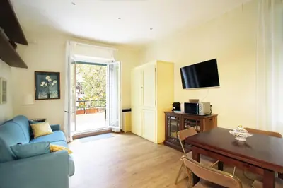 a living room with a blue couch and a table at Charming apartment in Trastevere in Rome