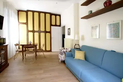 a living room with a blue couch and a table at Charming apartment in Trastevere in Rome