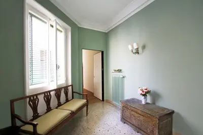 a room with a bench and a table and a window at Charming apartment in Trastevere in Rome