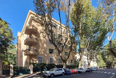 a building with cars parked in front of it at Charming apartment in Trastevere in Rome