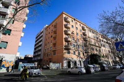 a tall building with cars parked in front of it at Sora Rosa in Rome