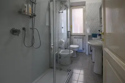 a bathroom with a shower and a toilet and a sink at Sora Rosa in Rome