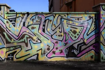 a wall with some graffiti on it at Sora Rosa in Rome