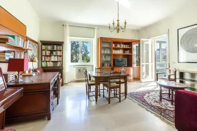 a living room with a table and a dining room at Casa di Sofia in Rome