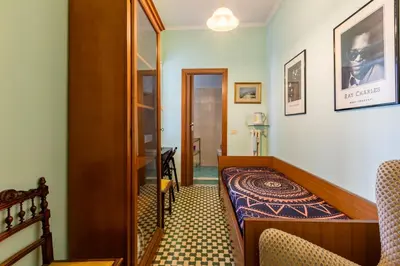 a small room with a bed and a corridor at Casa di Sofia in Rome