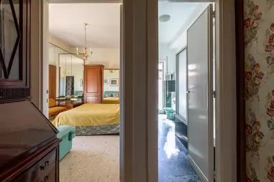 a room with a bedroom with a bed and a mirror at Casa di Sofia in Rome