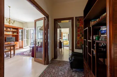 a hallway with a door open to a living room at Casa di Sofia in Rome
