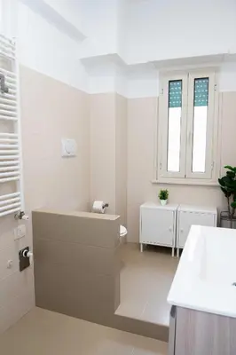 a white bathroom with a sink and a toilet at Vatican sweet view in Rome