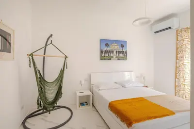 a bedroom with a hammock hanging over a bed at Sunrise House - San Paolo in Rome