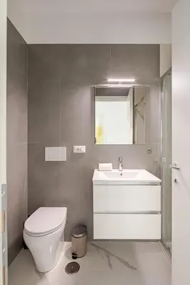 a bathroom with a toilet and a sink and a mirror at Sunrise House - San Paolo in Rome