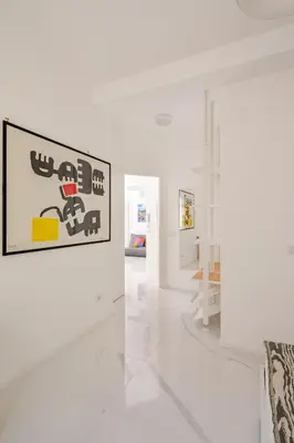 a white room with a picture on the wall at Sunrise House - San Paolo in Rome