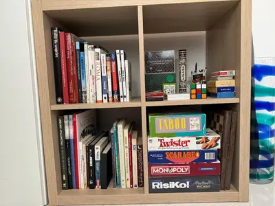 a book shelf with many books on it at Sunrise House - San Paolo in Rome