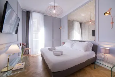 a bedroom with a white bed and a large window at Grand Master Suites in Rome