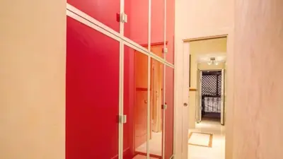 a room with a red wall and a mirror at Grand Master Suites in Rome